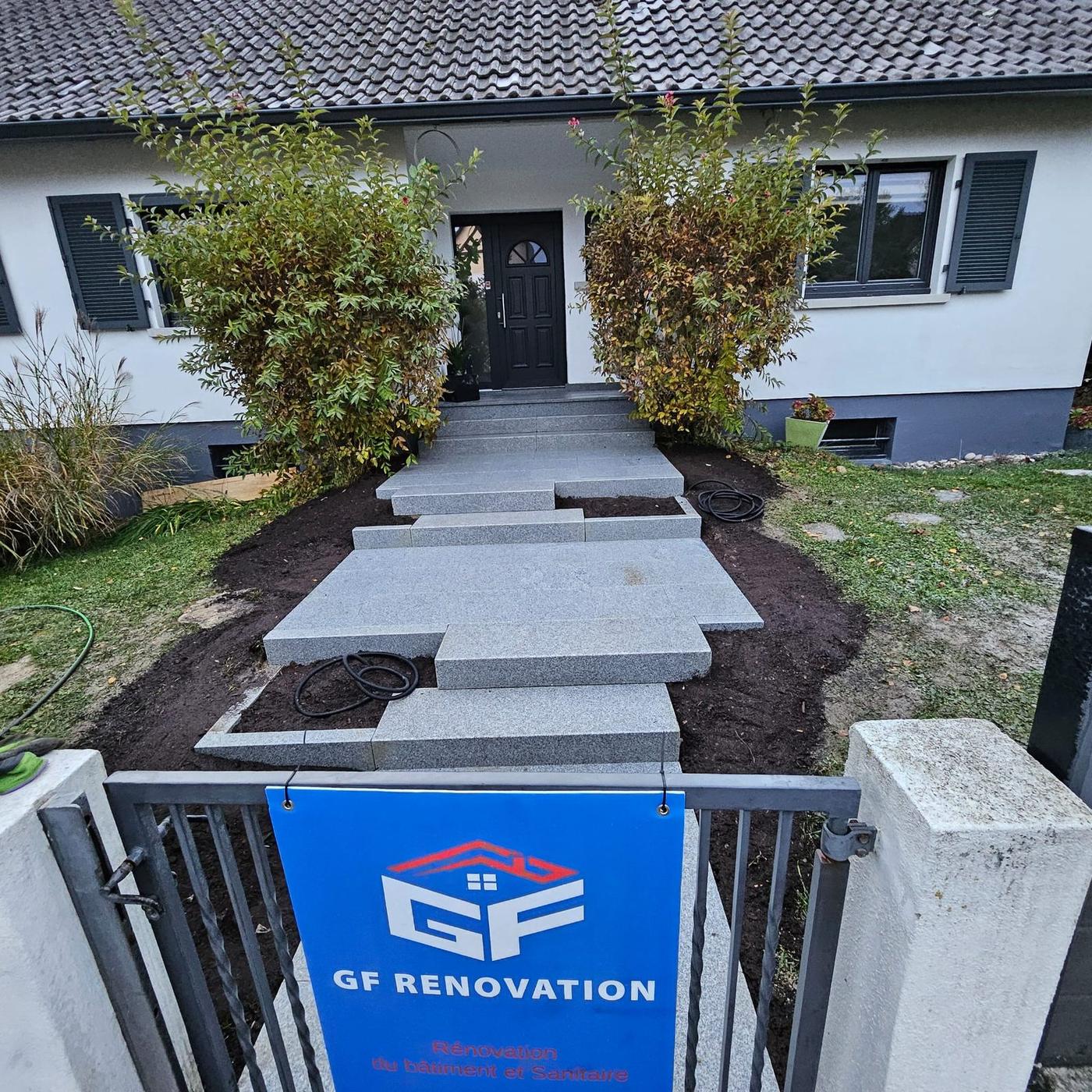 Allée d'accès en dalles de granit devant une maison